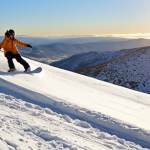 **Snowboarding in Serra da Estrela:** A snowboarder carving down a snowy slope in Serra da Estrela, Portugal. Focus on the bright, sunny day, with the white snow contrasting against the rugged mountain landscape. The snowboarder should appear to be enjoying the ride, with a sense of freedom and exhilaration.